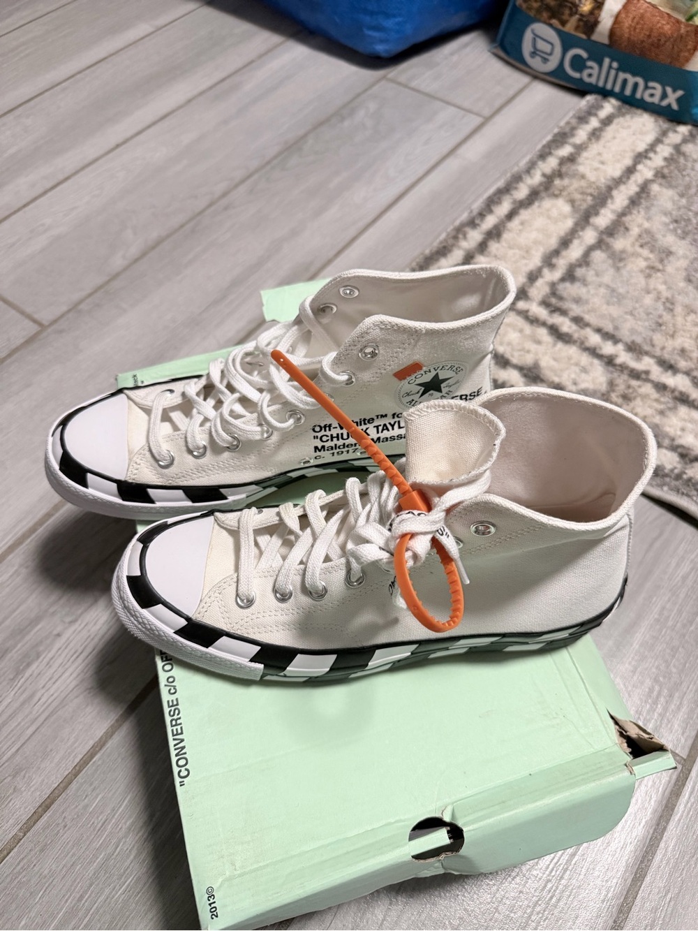 Converse White High Top Sneakers with Black Accents and Orange Tag